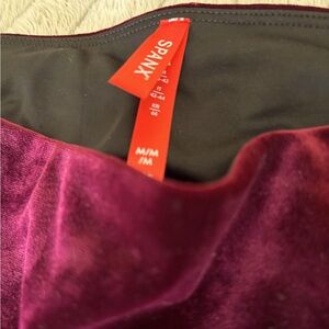 Maroon colored velvet Spanx tights.